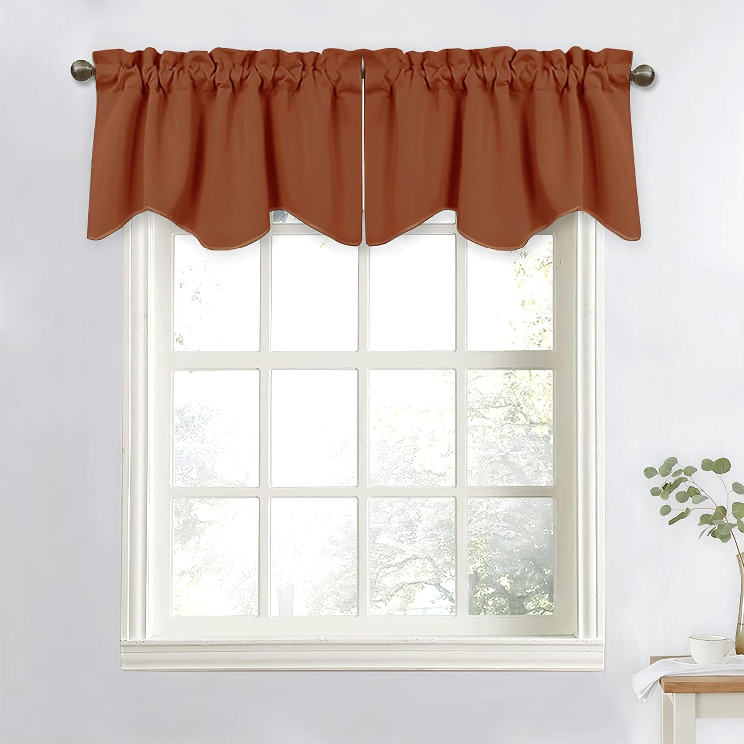 Burnt orange rod pocket window valance with a gathered top and decorative scalloped bottom edge.