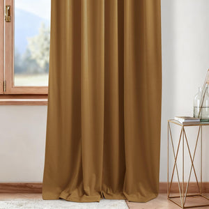 Rich caramel brown blackout curtain panel with soft folds, elegantly draped next to a wooden window.