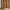 Modern caramel brown curtain panel with white wavy abstract lines, draped over a woven pouf.