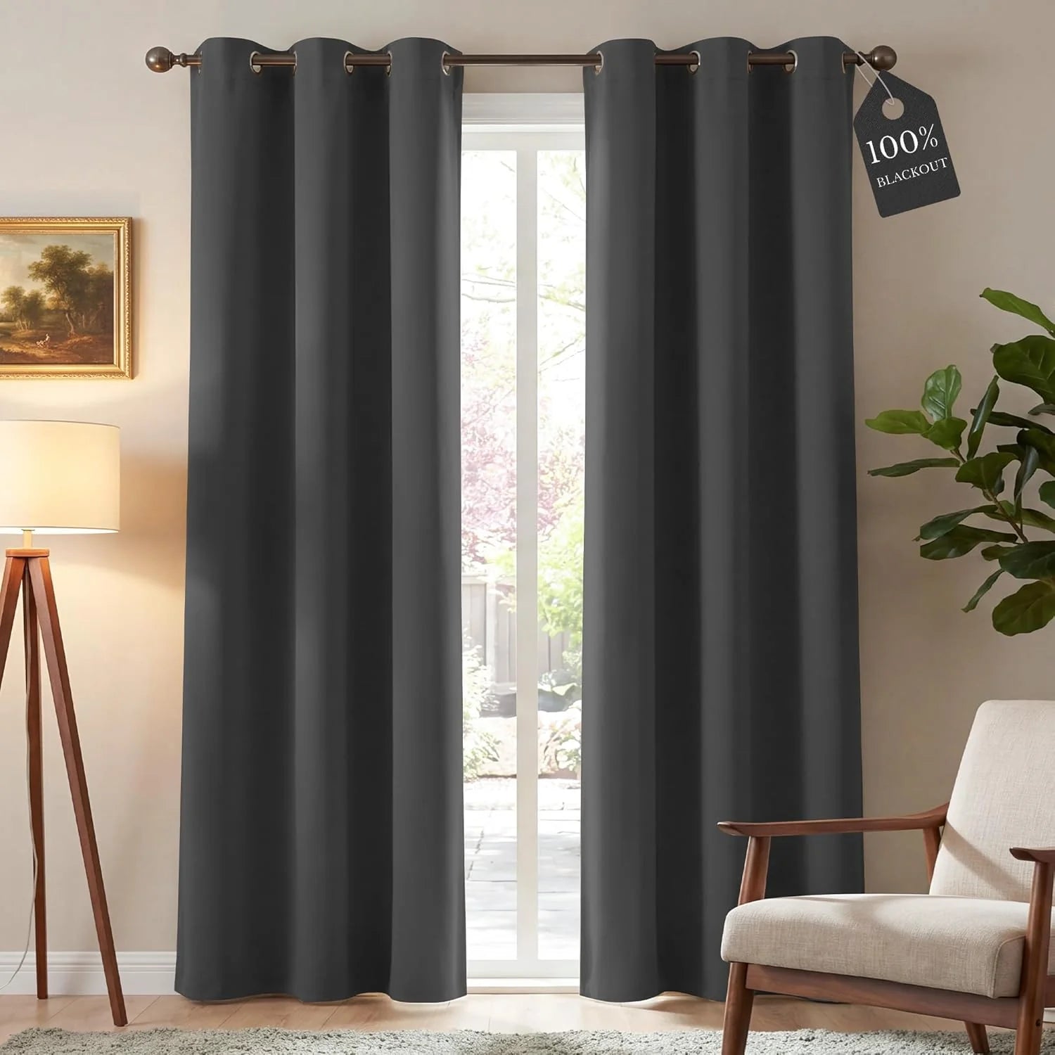Pair of charcoal gray 100% blackout curtains with grommet tops in a modern room.