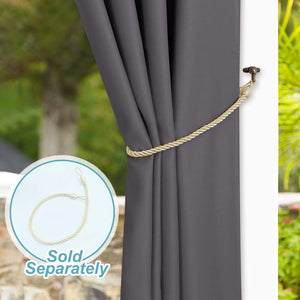 Smooth charcoal grey curtain panel secured by a braided gold rope tieback and dark metal hook at window.
