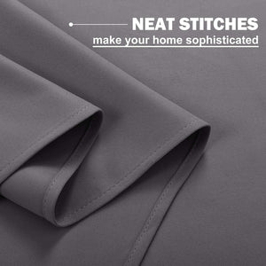 Charcoal gray blackout curtain fabric, showing close-up of neat, reinforced stitching along a folded hem.