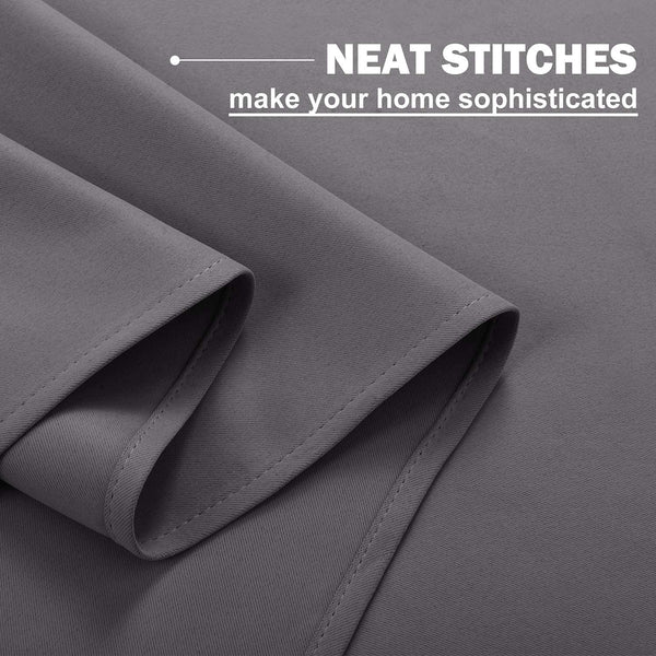 Charcoal gray blackout curtain fabric, showing close-up of neat, reinforced stitching along a folded hem.