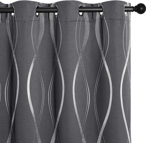Charcoal gray curtain panel with metallic silver wavy lines, grommet top on a black rod.