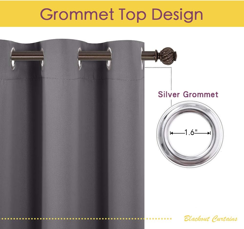 Close-up of charcoal gray blackout curtain with silver grommet top, hanging on a decorative bronze rod.