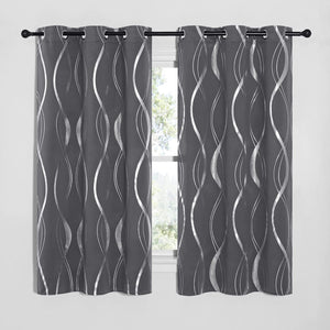 Pair of charcoal gray grommet top curtains with shimmering silver wavy abstract pattern hanging on a black rod.