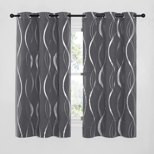 Pair of charcoal gray grommet top curtains with shimmering silver wavy abstract pattern hanging on a black rod.