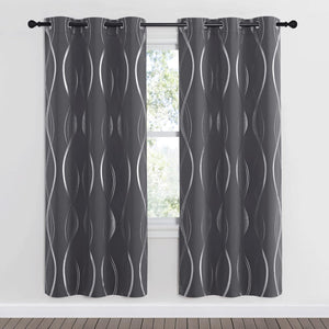 Modern charcoal gray curtains with shimmering silver foil wave patterns and grommet tops, framing a window.