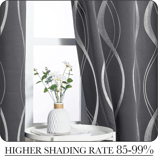 Charcoal grey curtains feature modern white abstract wavy line pattern, elegantly hung by a window.