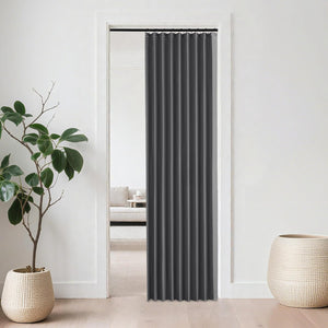 Charcoal grey accordion room divider curtain with grommet top in a modern doorway.