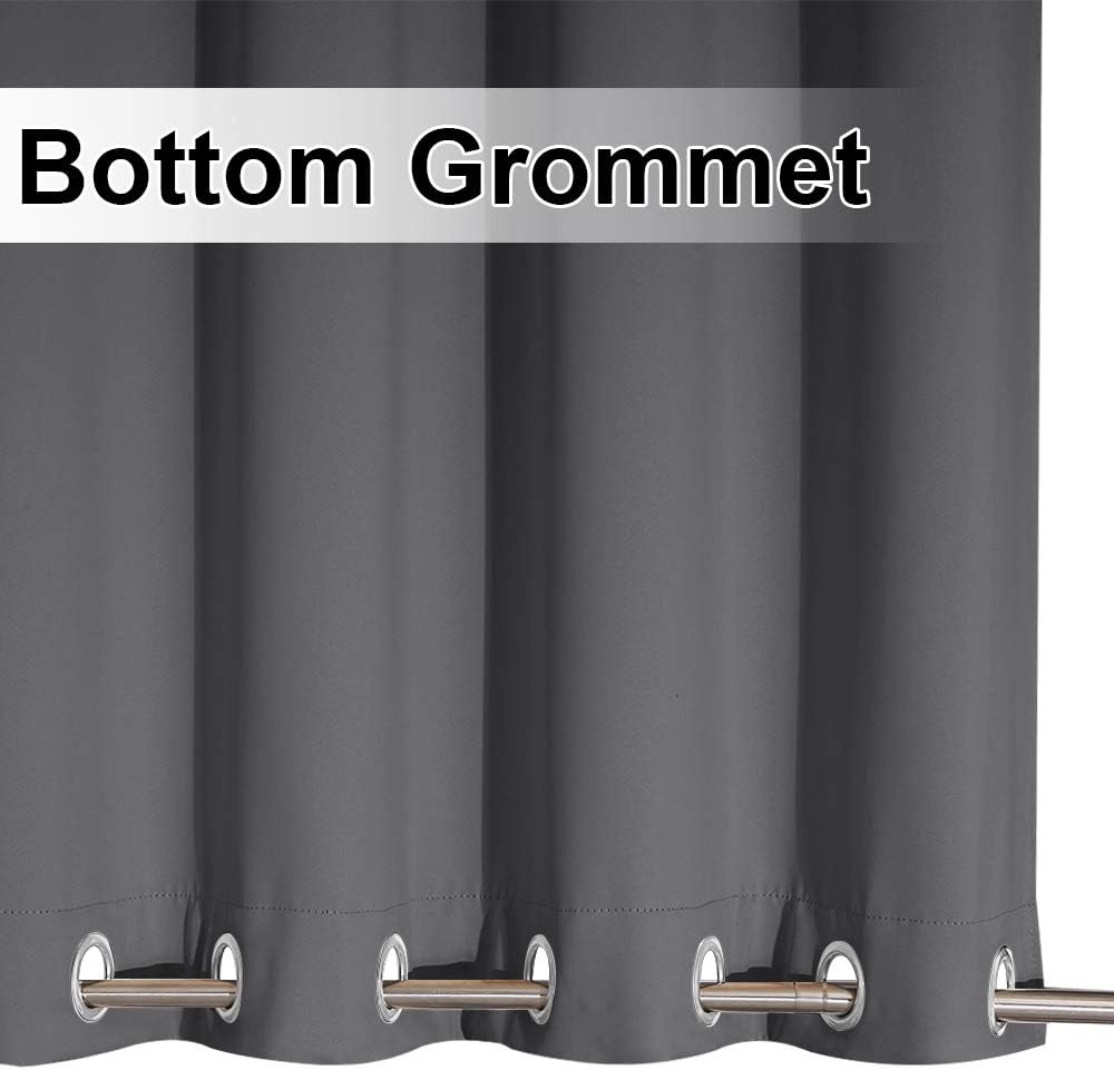 Close-up of a charcoal grey curtain panel showing several silver-toned grommets along its bottom hem.