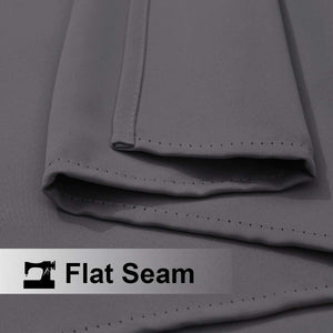 Close-up of charcoal grey woven fabric showing a clean flat seam with even stitching along the folded edge.