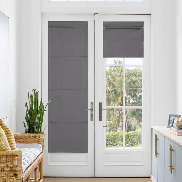 Charcoal grey flat roman shades on white French doors. One fully extended, other partially raised.