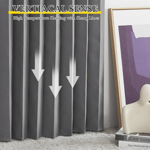 Charcoal grey curtains with crisp, vertically shaped pleats reaching the floor, beside a framed art piece.