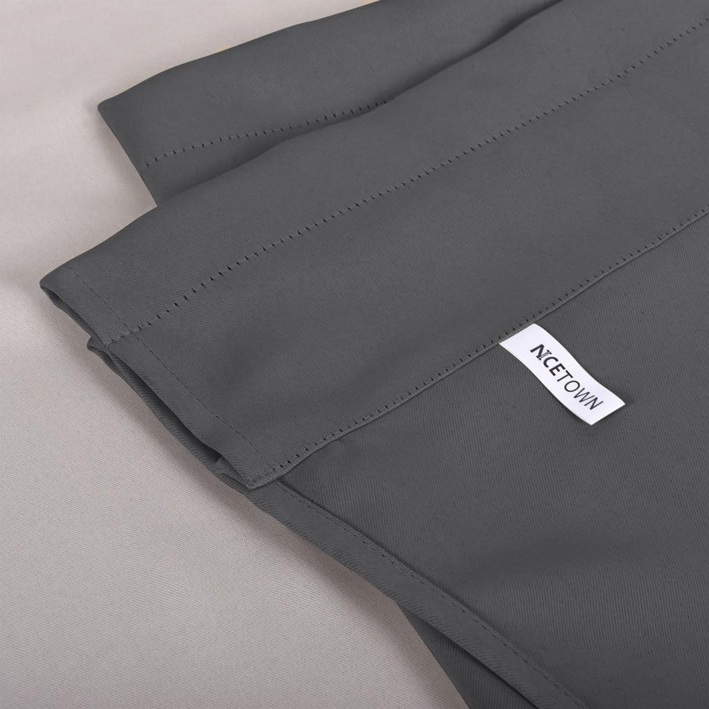 Close-up view of a charcoal grey solid curtain panel, highlighting its smooth fabric and neatly stitched top header.