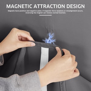 Person's hands revealing the magnetic closure design of a charcoal grey blackout curtain panel.