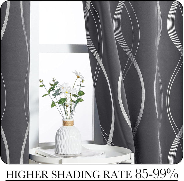 Modern charcoal blackout curtains with abstract silver wavy lines. Hanging on a bright window.