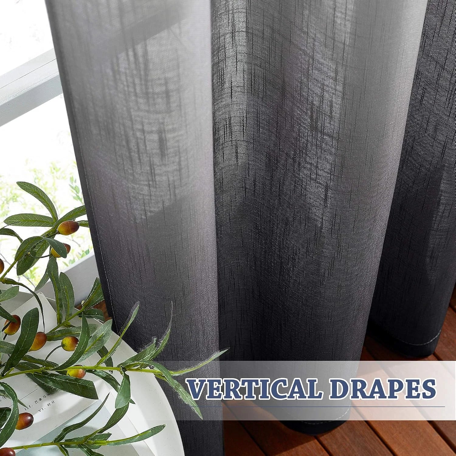 Charcoal sheer linen-look curtains hanging in soft vertical drapes by a bright window