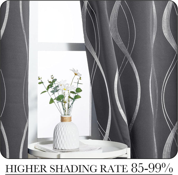 Charcoal blackout curtains with shimmering silver wavy lines, partly open, in a bright window.