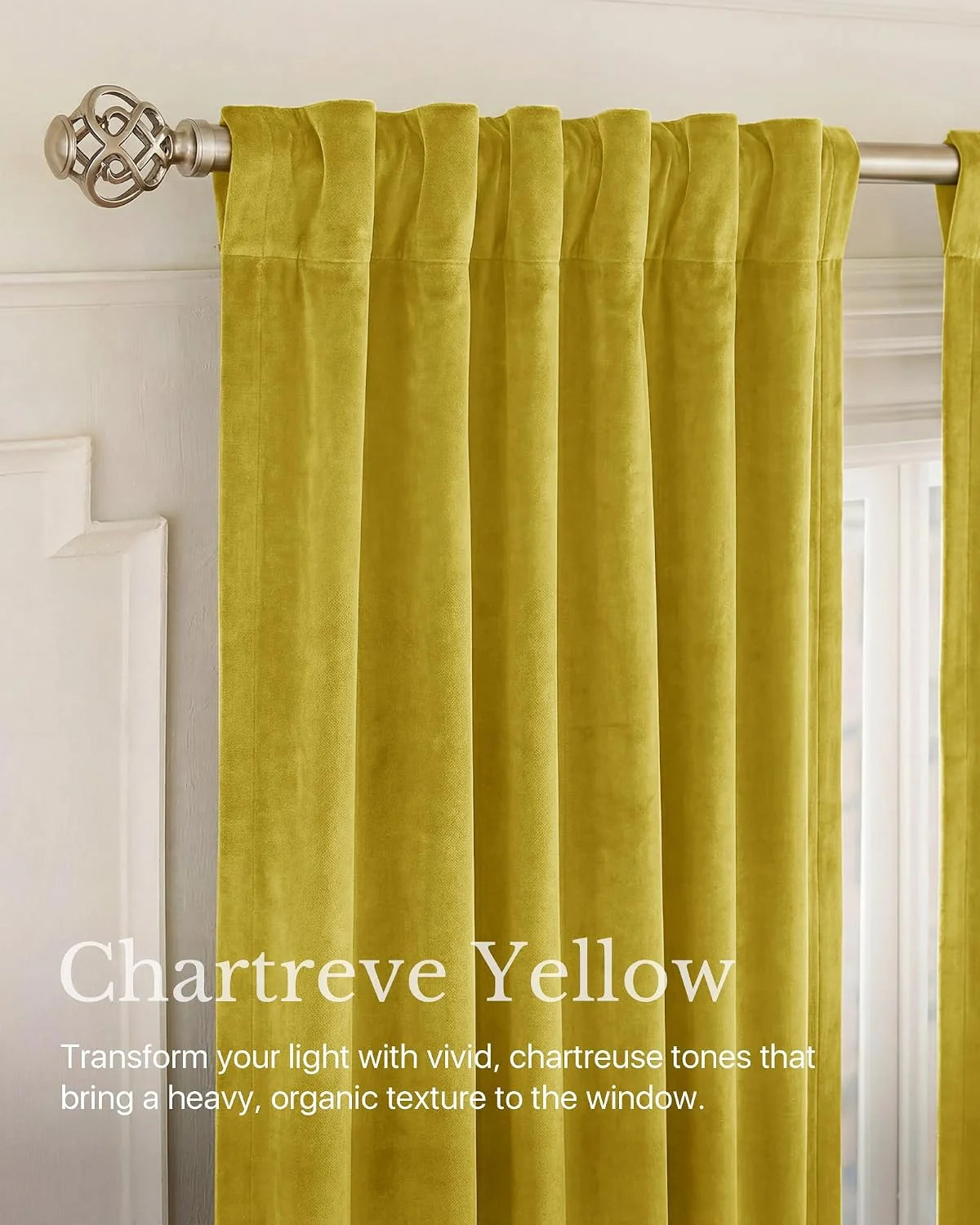 Chartreuse yellow velvet pleated curtain panel on a brushed metal rod