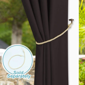 Dark brown curtain panel held back by a twisted gold rope tie-back on a bronze hook.