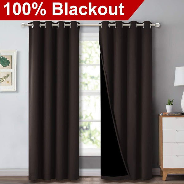 Chocolate brown grommet blackout curtains hang on a rod; one panel slightly open, revealing dark lining.