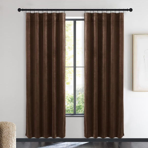 Rich chocolate brown velvet blackout curtains with pleated back tab header hung on a dark rod.