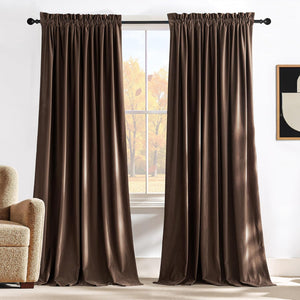 Chocolate brown velvet drapes with gathered rod pocket top hanging on a black curtain rod.