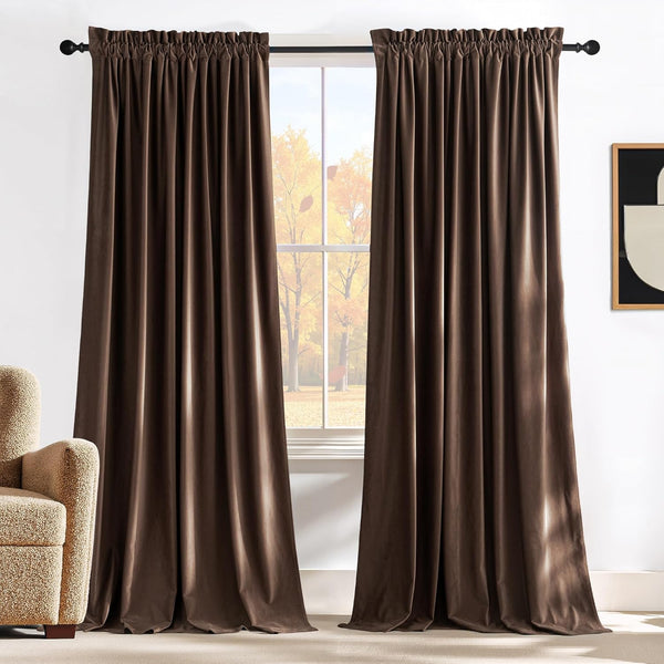 Chocolate brown velvet drapes with gathered rod pocket top hanging on a black curtain rod.
