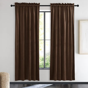 Pair of chocolate brown velvet rod pocket curtains with ruffled top, hanging on a window.