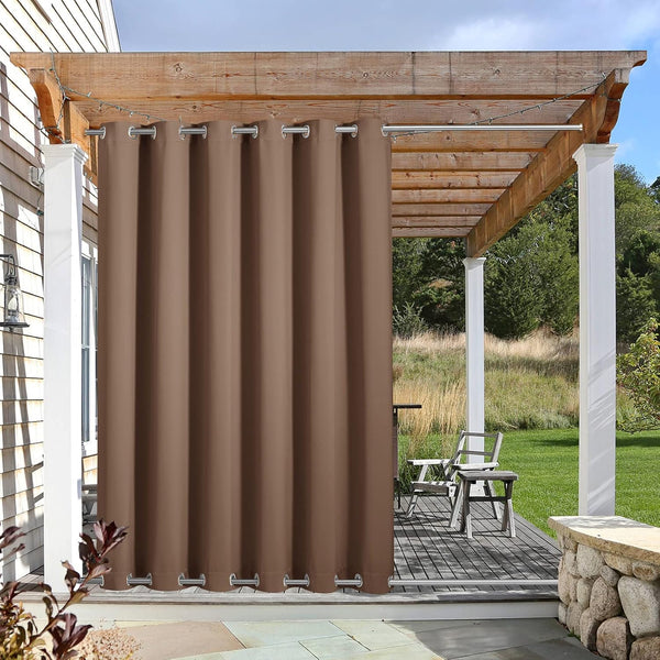 Coffee brown outdoor curtain with silver grommets hangs from a pergola, providing patio privacy.