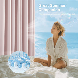 Woman relaxes on white cooling sheets by pink curtains, ocean view. Graphic shows fabric's cooling technology.