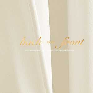 Close-up of cream blackout curtain fabric. Shows smooth front, textured back with interwoven black yarn.