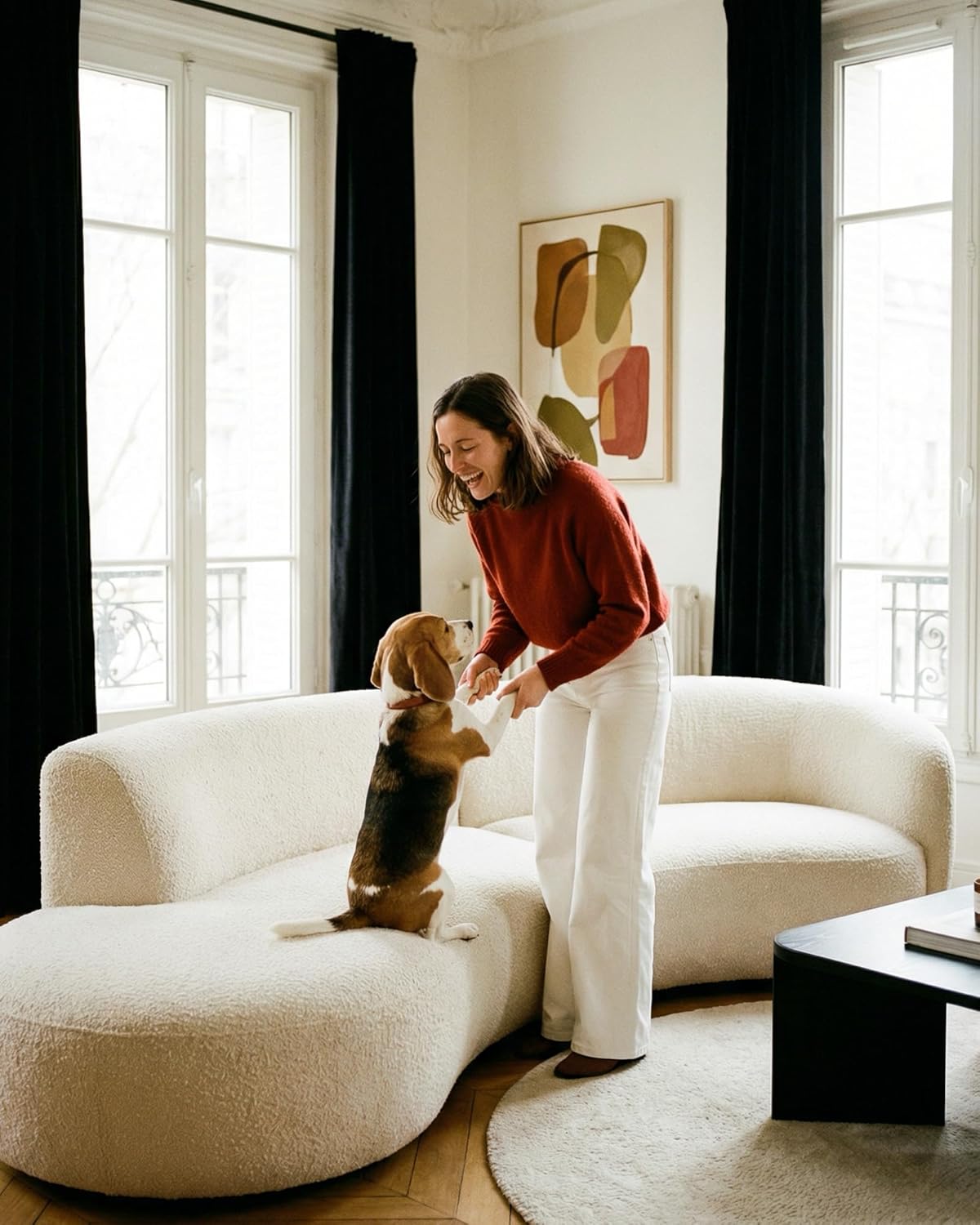 Off-white boucle curved sofa with unique organic shape and soft textured fabric in a modern living room.
