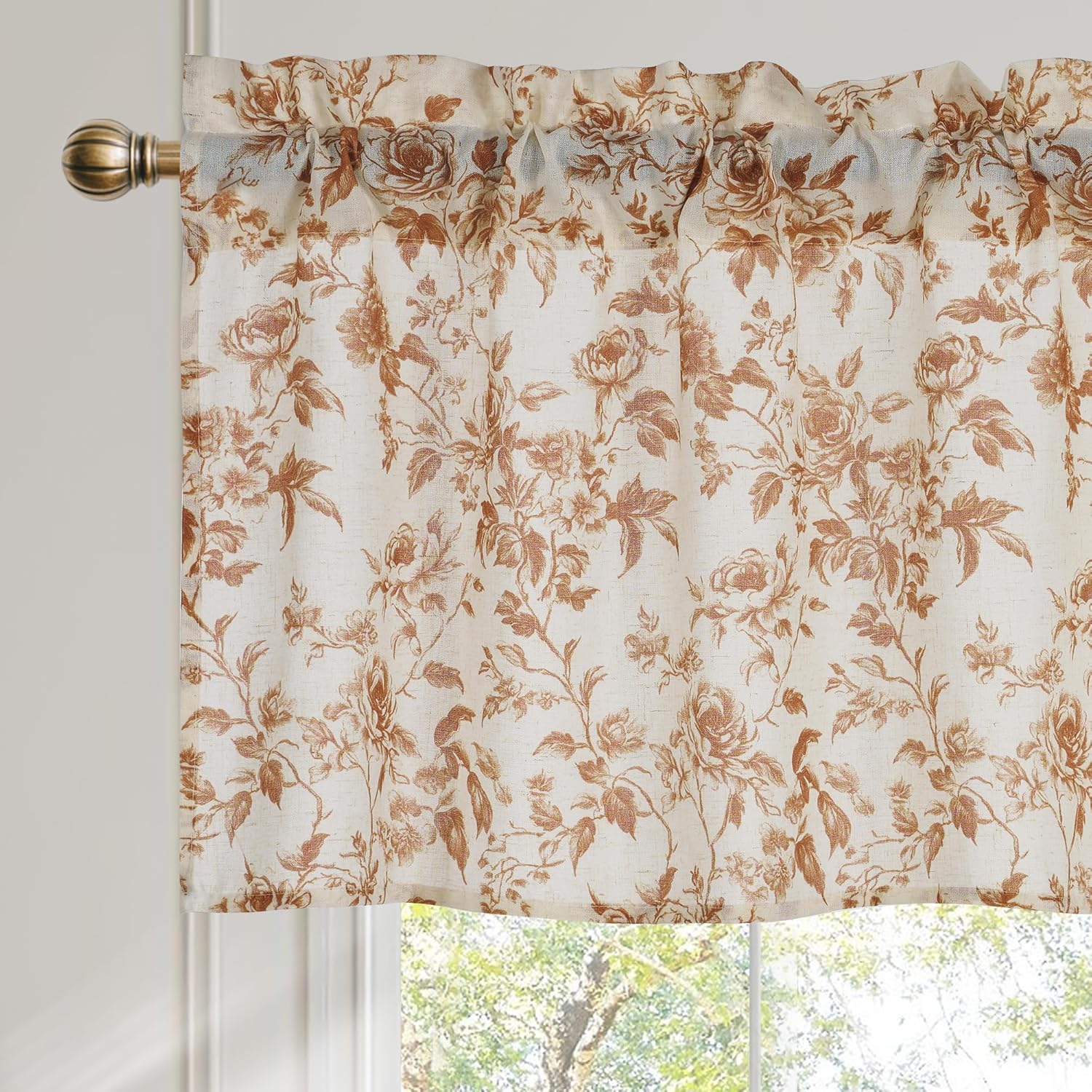 Cream and brown floral rose rod pocket valance with linen texture, hanging on a bronze rod.