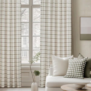 Full-length cream and brown plaid window curtains hanging elegantly in a bright modern living room setting.