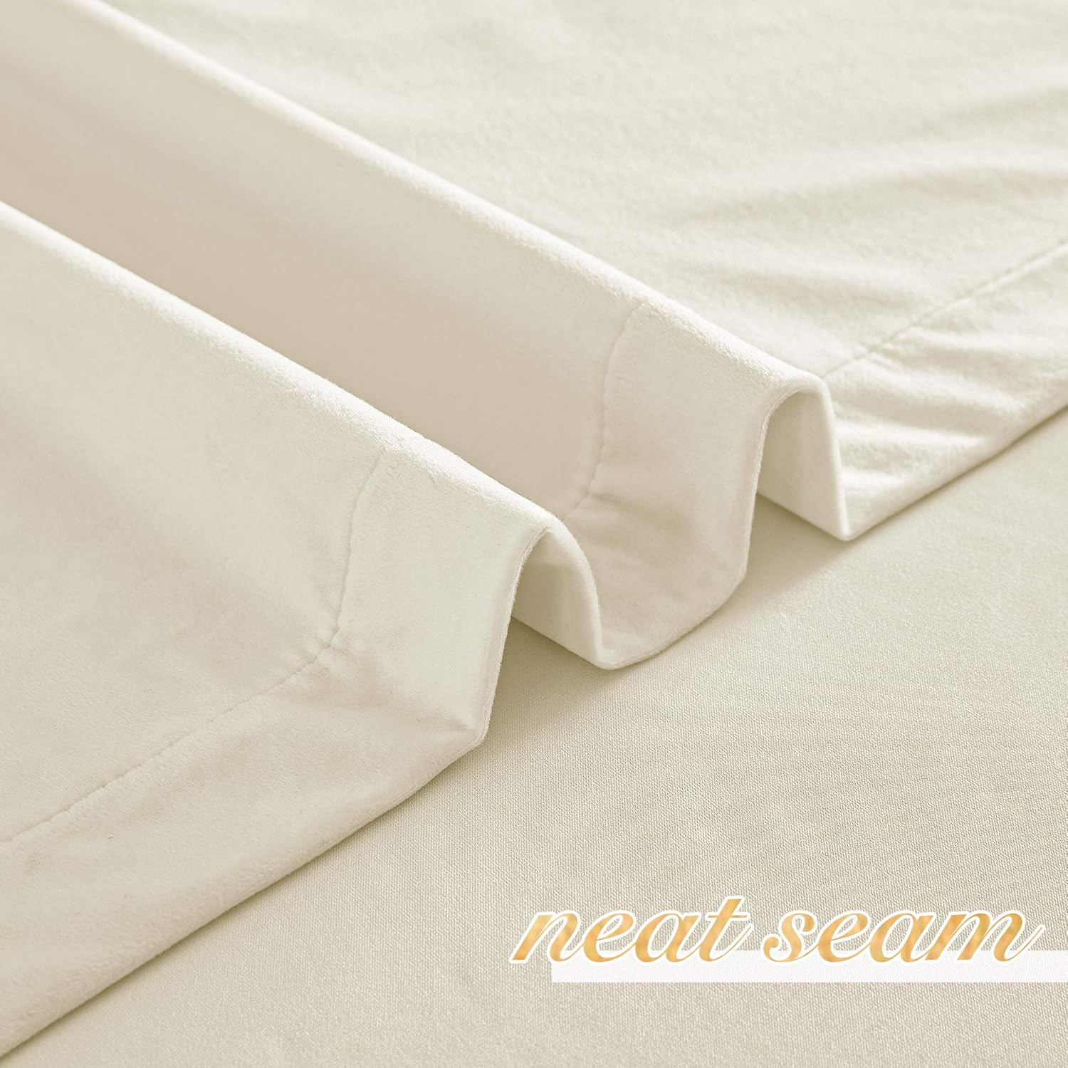 Close-up of folded cream-colored drapery fabric, highlighting a neat, well-stitched seam. The material appears soft and thick.
