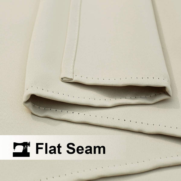Close-up of cream fabric with a flat seam, featuring neat, visible stitching. Highlights durable textile construction.