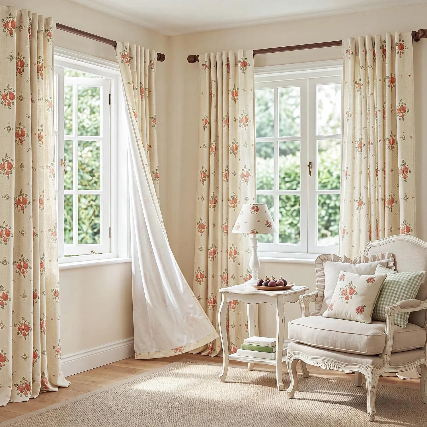 Cream floral curtains on wooden rods in a soft, elegant bedroom reading corner
