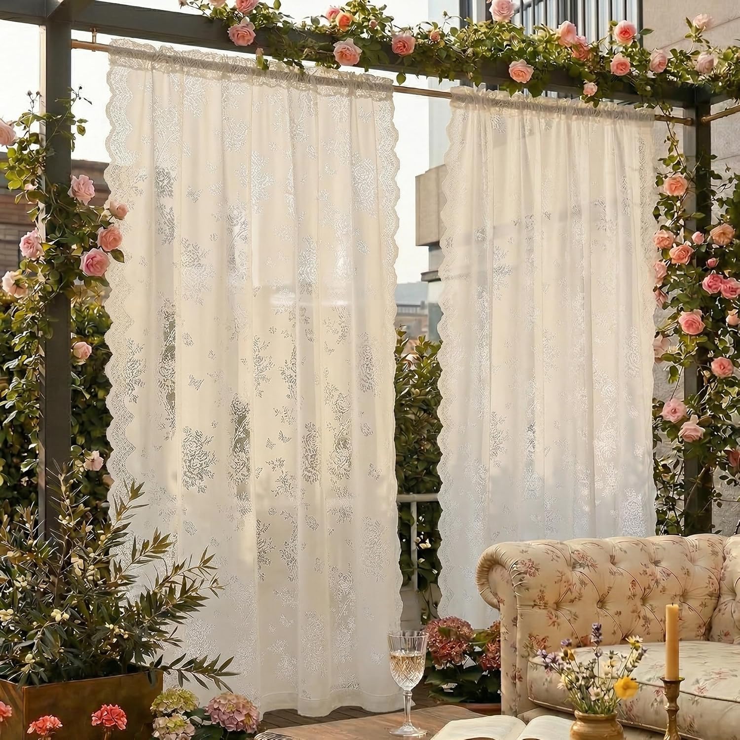 Cream sheer curtains with delicate floral lace pattern and scalloped edges on an outdoor patio.