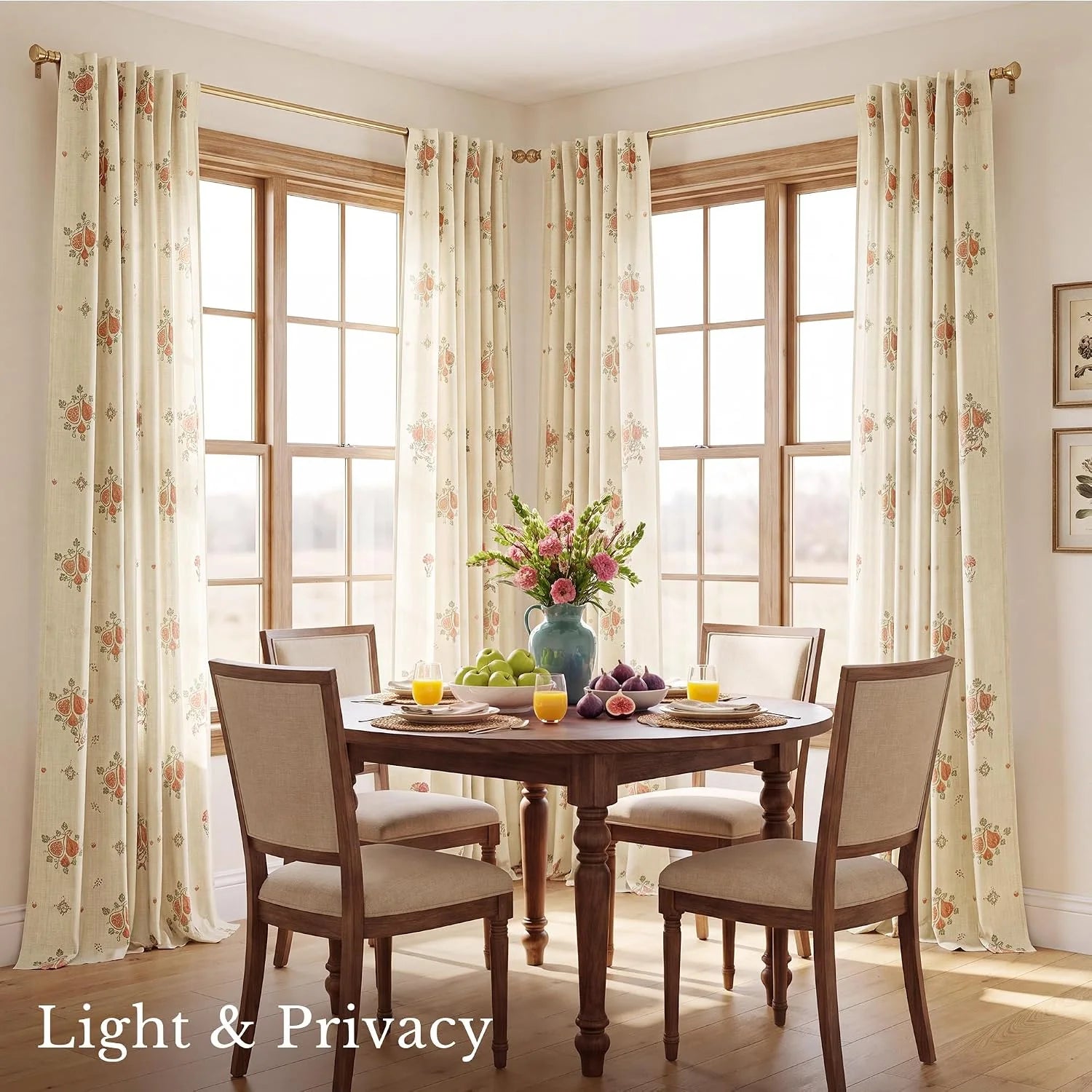 Cream floral curtains on brass rods framing corner dining room windows