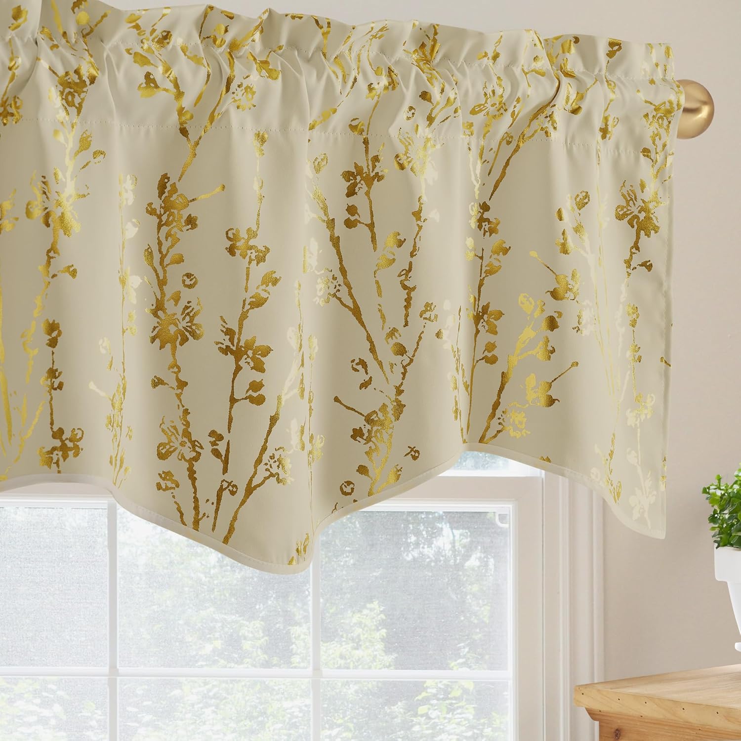 Cream window valance with shimmering gold floral branches, rod pocket top, and a curved hem.