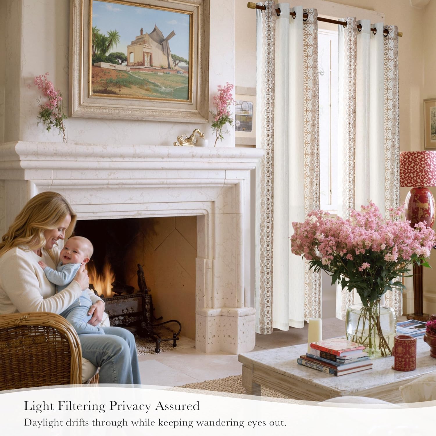 Cream light filtering curtains with patterned geometric trim and grommet tops in a living room.