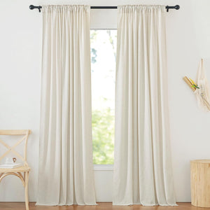 Cream linen blend window panels with a gathered rod pocket top, hanging from a black rod over a sunlit window.