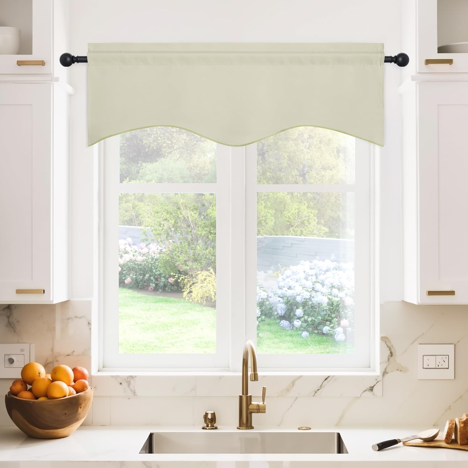 Cream fabric rod pocket valance with a subtle scalloped bottom edge, installed over a kitchen window.
