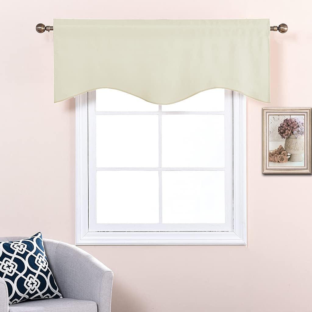 Cream scalloped rod pocket window valance hanging on a bronze rod over a white-framed window.