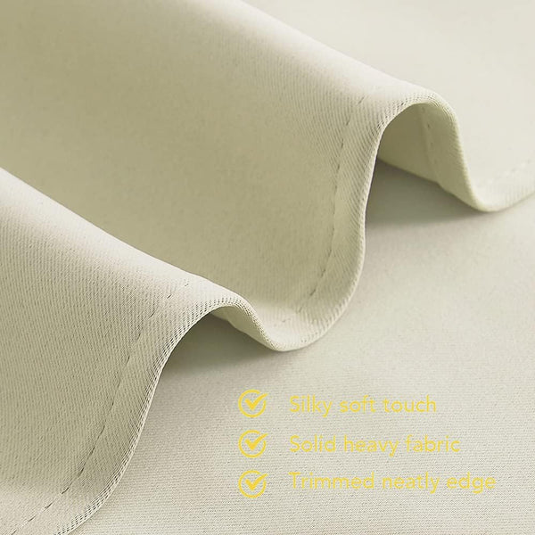 Close-up of cream-colored, silky soft and heavy drape fabric, featuring a neatly trimmed edge.