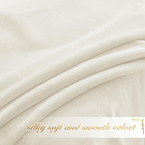 Close-up of light cream velvet fabric, showcasing its silky-soft and smooth texture with gentle folds.