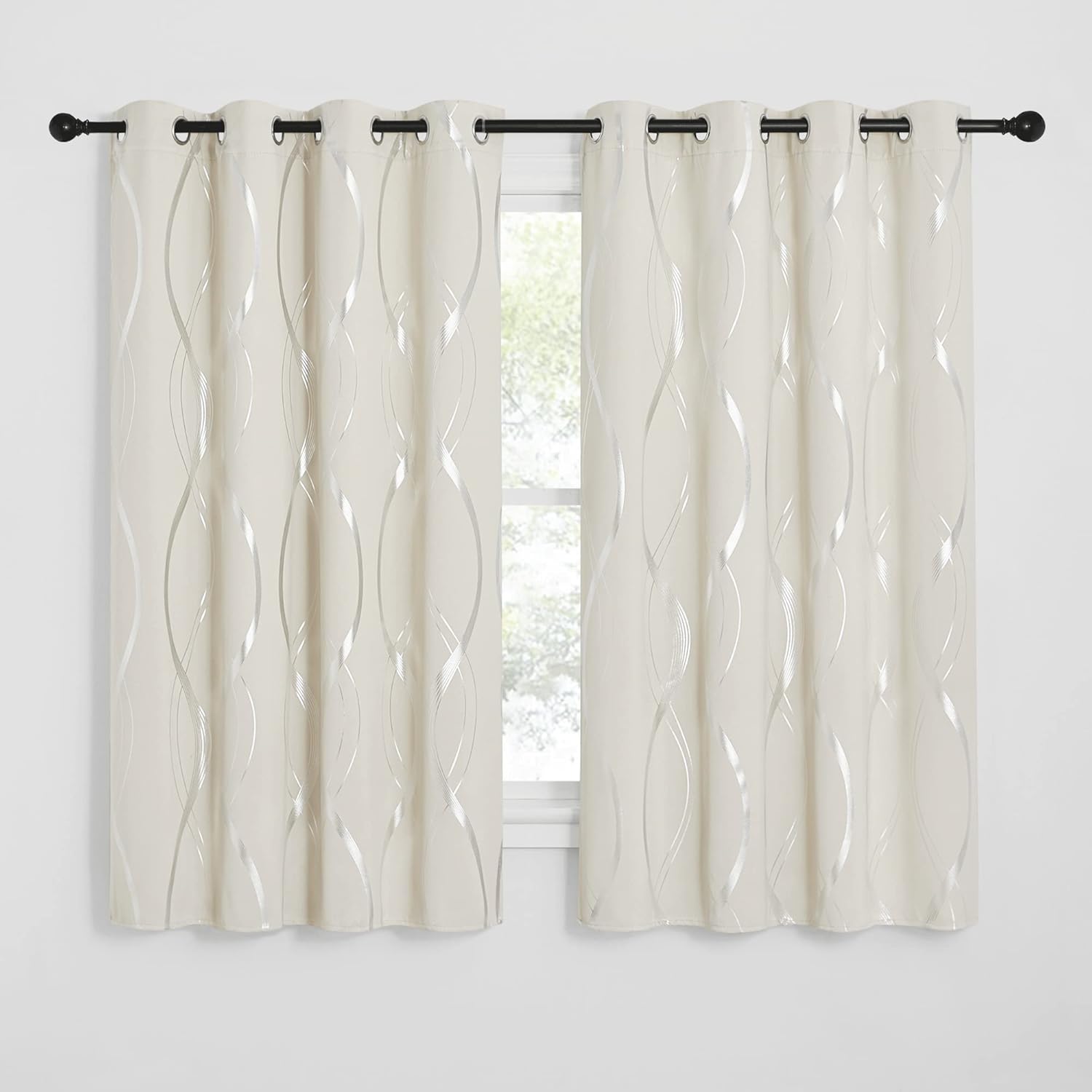 Cream grommet curtains featuring a modern metallic silver wavy pattern on a black rod.