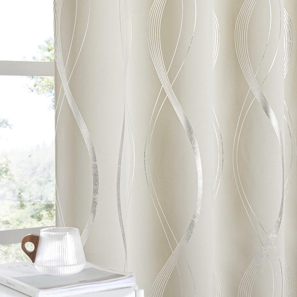 Cream opaque curtains with shimmering silver wavy lines, seen by a sunlit window.